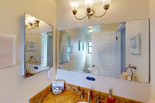 a bathroom with a sink and a large mirror at Awesome Views in Cambria