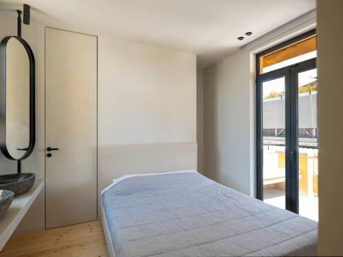 a bedroom with a bed and a sliding glass door at Hoppersgr- Amazing apt in the heart of Athens - 6 in Athens