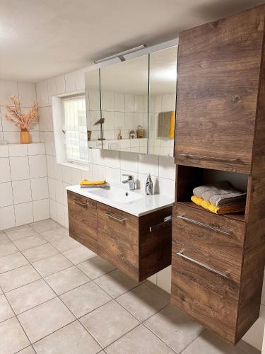 a bathroom with a sink and a mirror at Ferienwohnung Lux in Weißenburg in Bayern