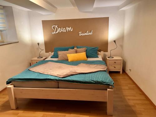 a bedroom with a bed with a sign on the wall at Ferienwohnung Lux in Weißenburg in Bayern