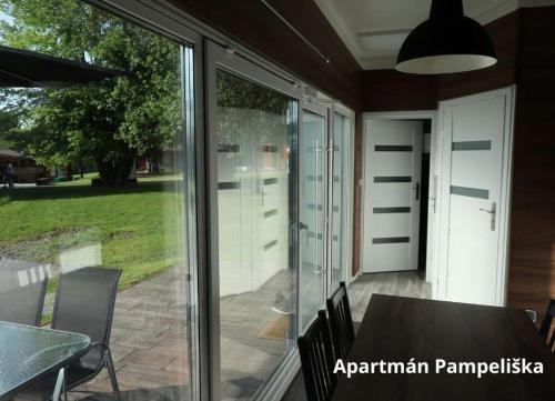a screened in porch with a table and chairs at Apartmány Štramberk in Štramberk