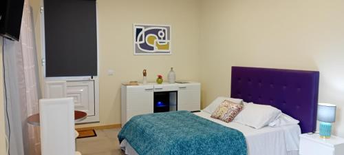 a bedroom with a bed with a blue head board at Apart Monumental in Funchal