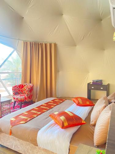 a bed in a room with two pillows on it at Hasan Zawaideh Camp in Wadi Rum