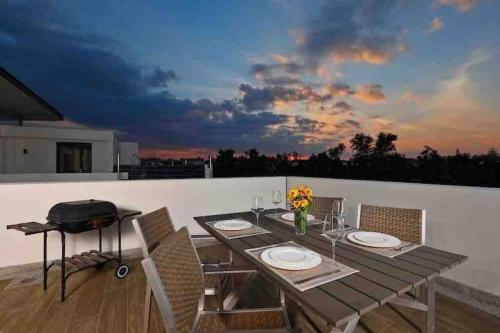 a dining table and chairs on a balcony at Big Lucky home in Laguna park in Bang Tao Beach