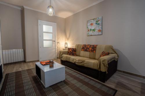 a living room with a couch and a table at Lembranzas in Padrón