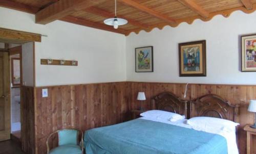 a bedroom with a bed with a blue bedspread at Agriturismo Casanuova in Carobbio