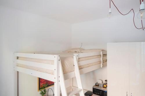 a bunk bed in a room with a ladder at Lovely Private Room in Milan