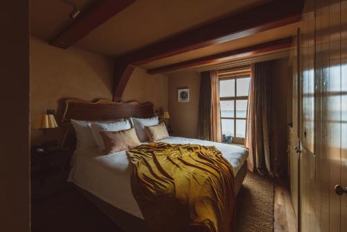a bedroom with a large bed and a window at De Durgerdam, Amsterdam in Amsterdam