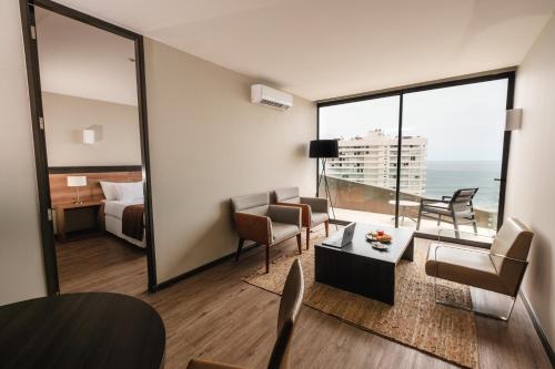 a hotel room with a view of the ocean at Terrado Club Iquique in Iquique