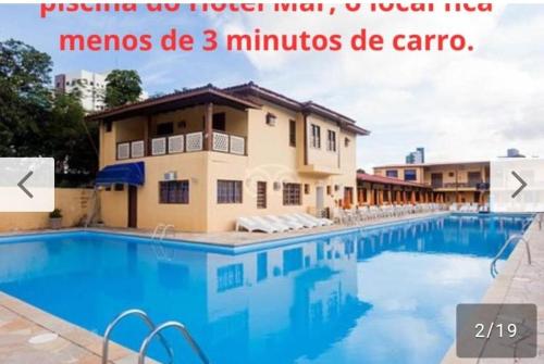 a picture of a swimming pool at a hotel at Kitnets em Caraguatatuba in Caraguatatuba