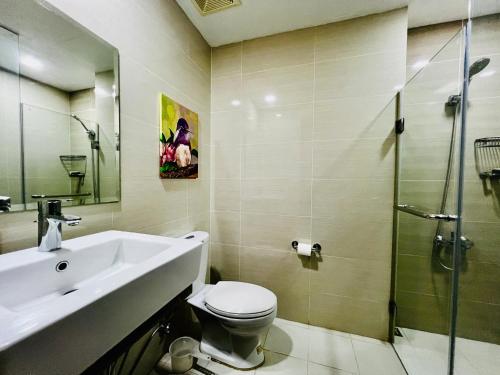 a bathroom with a sink and a toilet and a shower at Deluxe Queen 1BR Luxury Suite 17 - Pool, City View in Manila