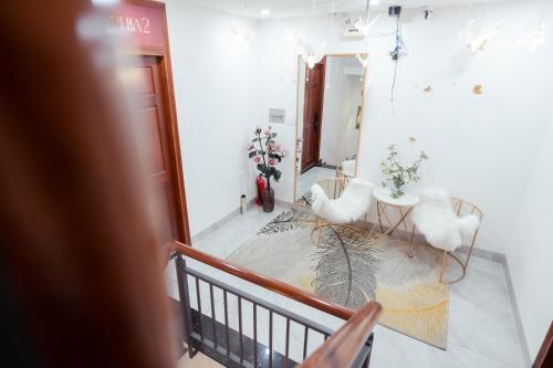 a room with a staircase with white walls and a mirror at The Sophia Apartment - Thao Dien Central in Ho Chi Minh City