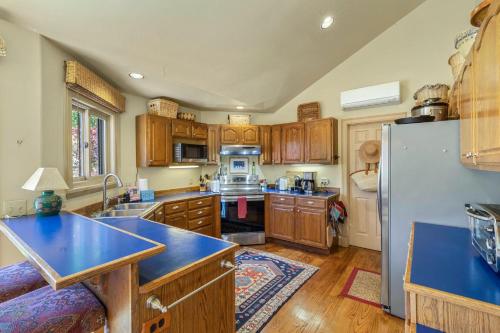 a kitchen with wooden cabinets and a blue counter top at Mountain View in Ouray