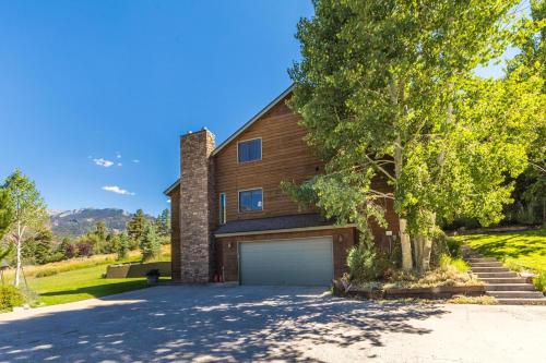 a house with a garage and a tree at Mountain View in Ouray