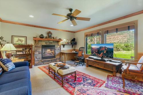 a living room with a blue couch and a fireplace at Mountain View in Ouray