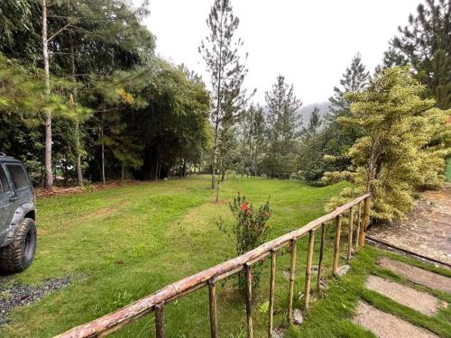 a car parked in a yard next to a fence at Villa Don Manuel in Villa Altagracia