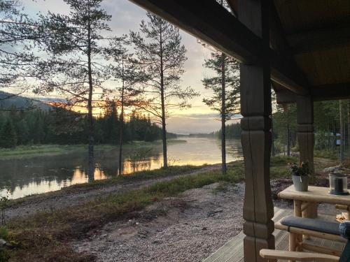 a view of a river from a porch of a house at ElveRo Lodge in Trysil