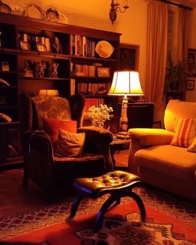 a living room with a chair and a table at Real Santo António Guest House in Tarouca