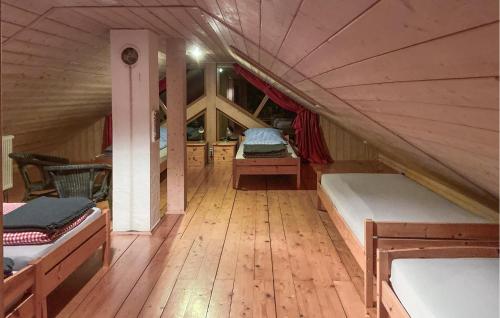 a room with three beds in a attic at 2 Bedroom Amazing Home In Wartmannsroth in Wartmannsroth