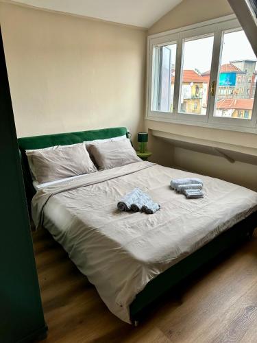 a bed in a bedroom with two towels on it at Casa Valprato in Turin