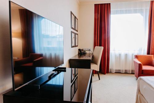 a hotel room with a desk and a tv at Crowne Plaza Bratislava, an IHG Hotel in Bratislava