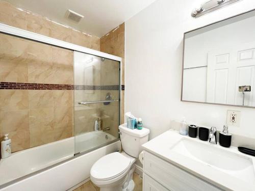 a bathroom with a toilet and a sink and a shower at 570 BayFair 5Br Coze home with Greatviews 