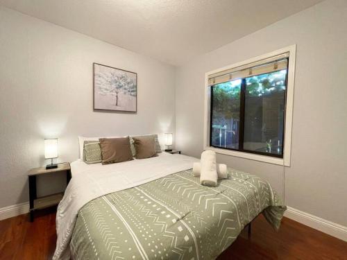 a bedroom with a large bed and a window at 570 BayFair 5Br Coze home with Greatviews 