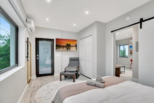 a bedroom with a large bed and a chair at Condo Right off Las Olas Steps to FTL Beach 1A in Fort Lauderdale