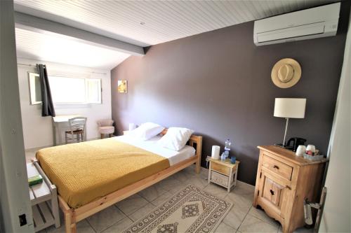 a bedroom with a large bed and a room with a window at B&B et Gite d'ayran in Saint-Quentin-la-Poterie