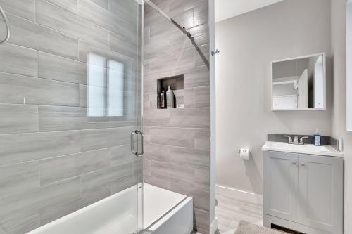 a bathroom with a shower and a toilet and a sink at 2 Condo Combo Walk to Beach Off Las Olas 2AB in Fort Lauderdale