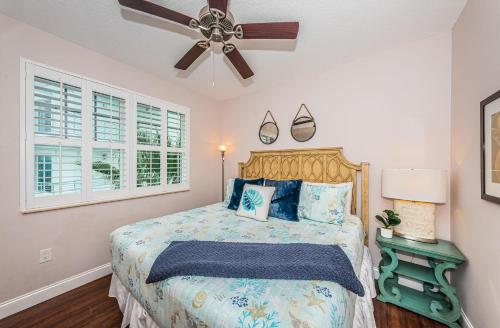 a bedroom with a bed and a ceiling fan at Treasure Trove Flying Dutchman in St Pete Beach