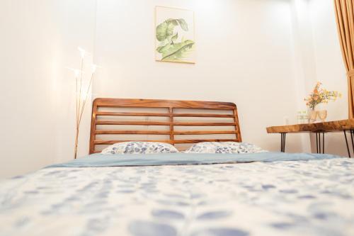 a bedroom with a bed and a table at The Sophia Apartment - Thao Dien Central in Ho Chi Minh City