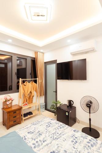 a bedroom with a bed and a fan at The Sophia Apartment - Thao Dien Central in Ho Chi Minh City