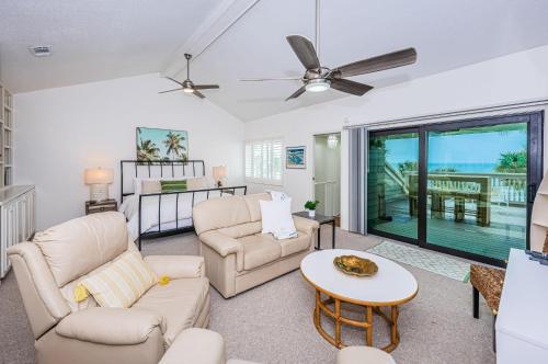 a living room with two couches and a table at Beachfront Aldea 14 in Clearwater Beach