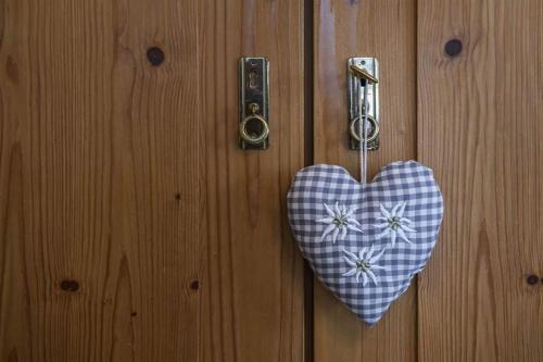 a heart shaped door knocker on a wooden door at Alpasella Ferienwohnungen in Sankt Gallenkirch