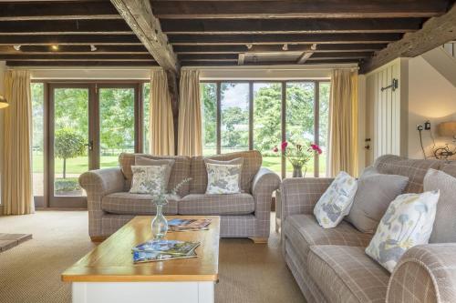 a living room with couches and a table at The Granary in Oulton