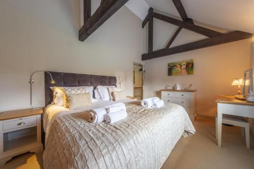 a bedroom with a bed with two towels on it at The Granary in Oulton