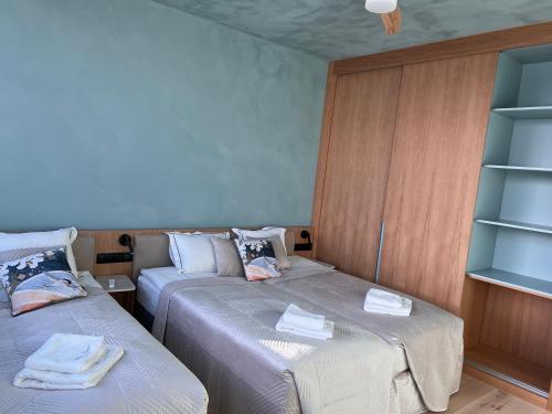 a room with two beds with towels on them at LedowoHouse Industrial Style kids friendly in Lędowo