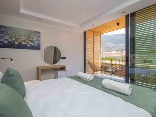 a bedroom with a large bed and a large window at Asfiya Loft Apartments in Kas