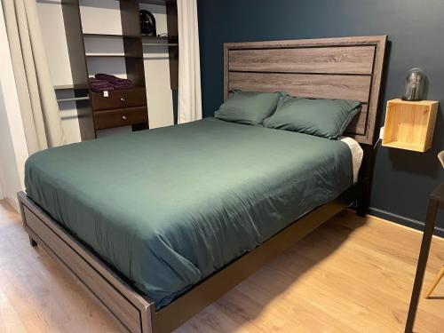 a bedroom with a bed with a wooden headboard at Cosy Private Room in Downtown with Free Parking - Self entrance in Calgary