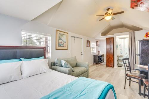 a bedroom with a bed and a chair and a couch at Lakefront Panama City Studio with Hot Tub Access in Panama City