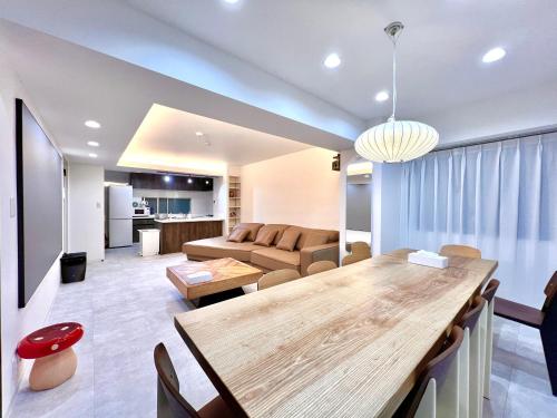 a living room with a table and a couch at LoveTokyo Maisonette Terrace in Tokyo