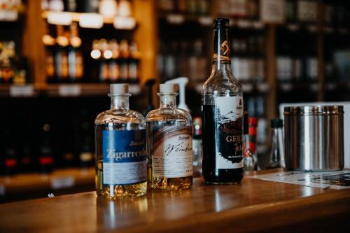 three bottles of alcohol sitting on a table at Sonnenhotel Hoher Hahn in Schwarzenberg