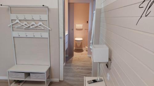 a bathroom with a closet with a toilet in it at Le petit nid douillet in Trescléoux