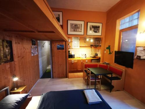 a room with a bed and a table and a kitchen at High Sky Apartment in Budapest