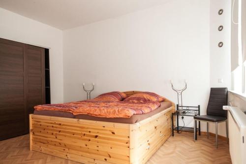 a bedroom with a wooden bed in a room at Gemütliche Ferienwohnung in Lerbach mit Garten, Grill und Terrasse in Lerbach