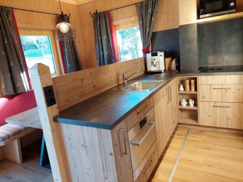 a kitchen with a sink and a counter top at Appartements Stadlerhof in Kramsach