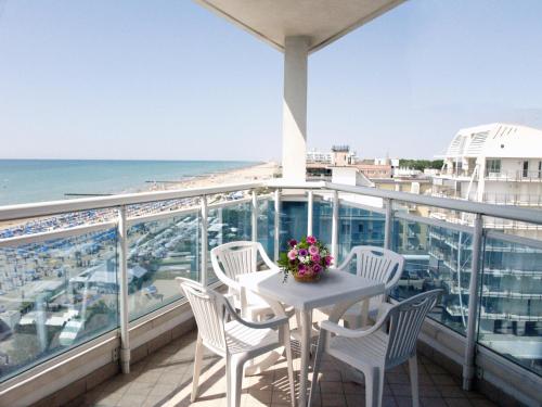 a balcony with a table and chairs and the ocean at Hotel Caravelle&MiniCaravelle in Lido di Jesolo