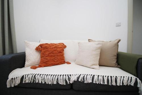 a pillow on a couch with pillows on it at Old Market House 3 BR close to town centre in Newport