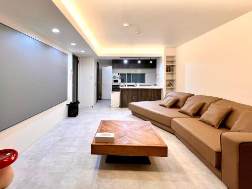 a living room with a couch and a coffee table at LoveTokyo Maisonette Terrace in Tokyo